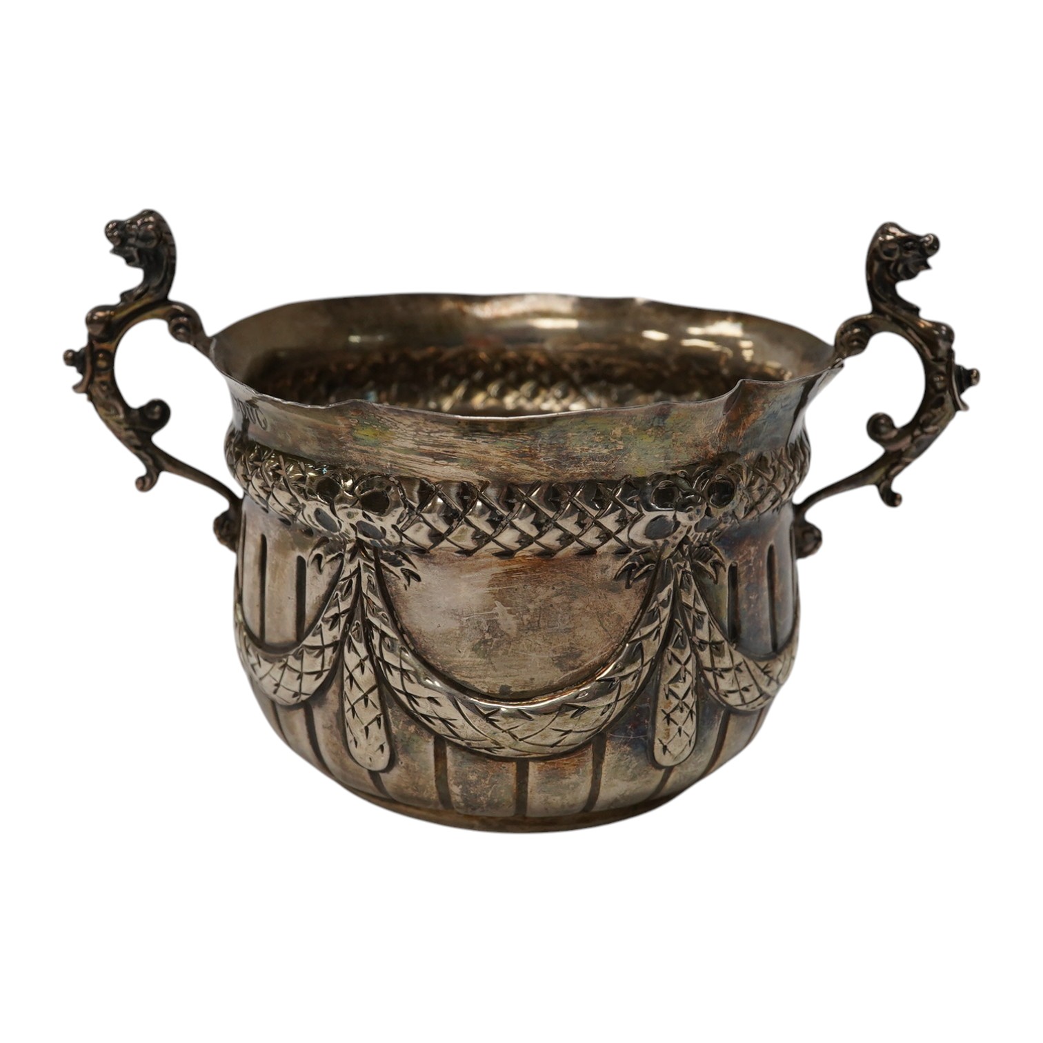 A late Victorian repousse silver porringer, maker JR, London 1884, height 82mm, 3.8oz. Condition - poor